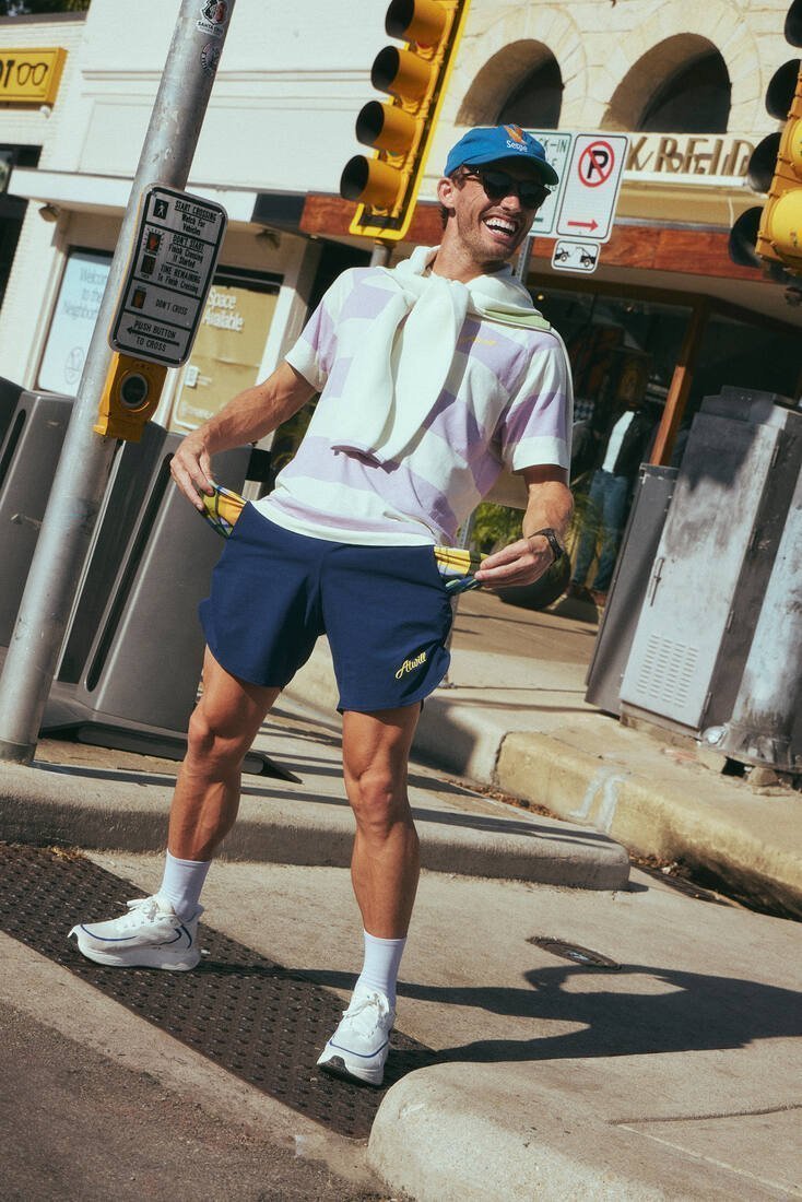 Runner in the Ellis Tee laughing at an Austin crosswalk